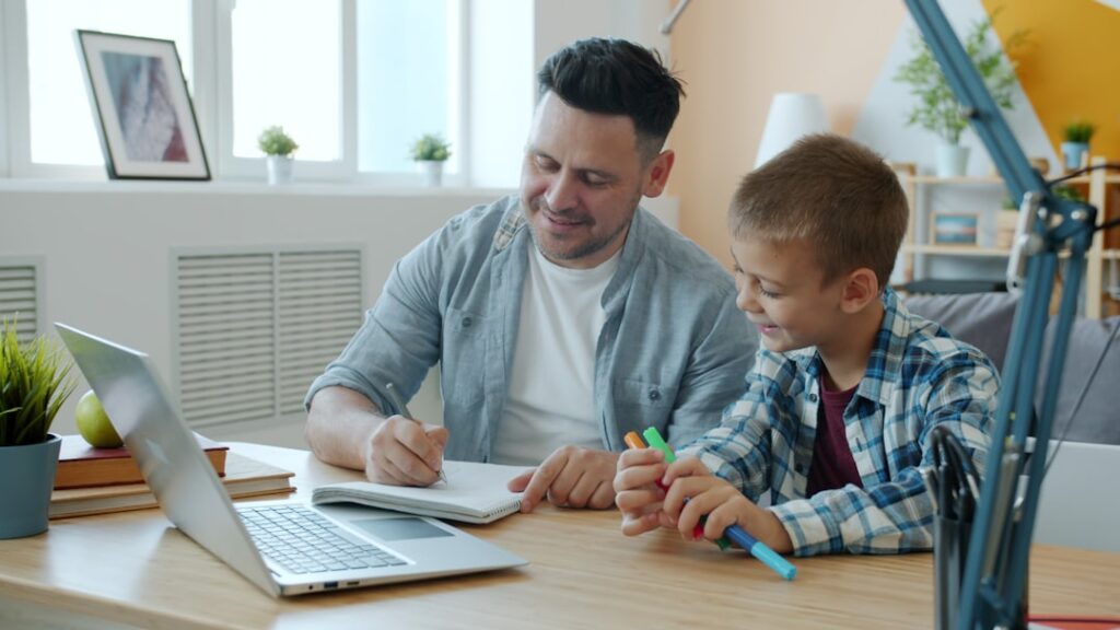 Parent with a thoughtful expression sits in a brightly lit, modern living room, researching on their laptop, symbolizing t...