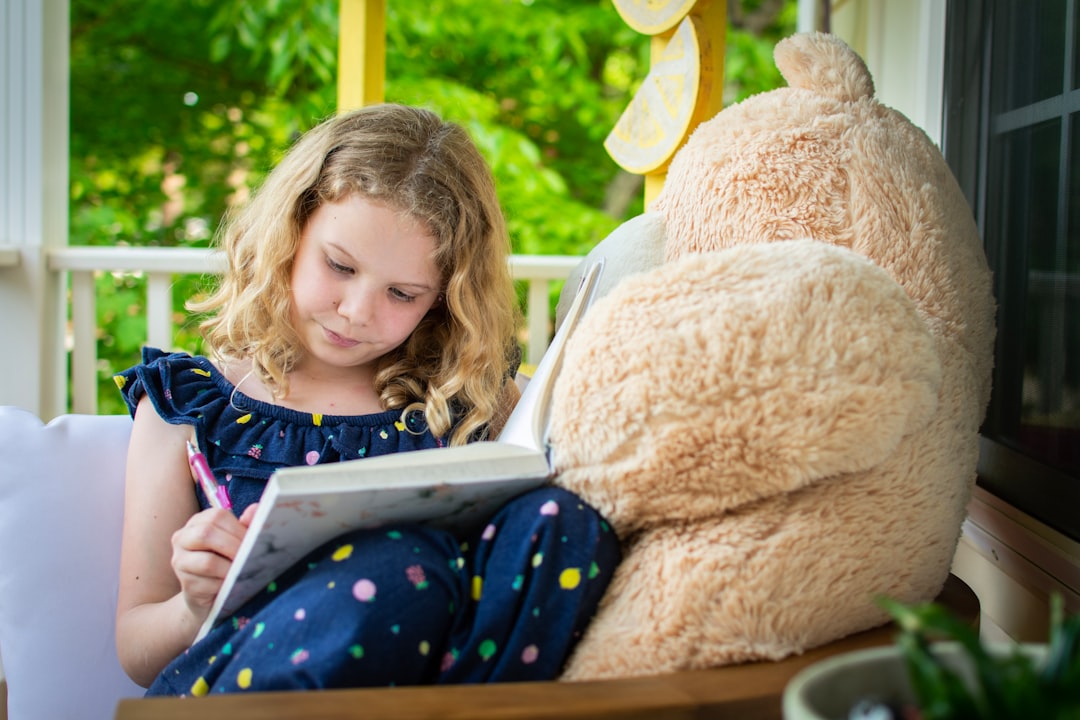 A young child sits peacefully in a sunlit room, fully engaged and focused on a tablet, representing a positive and non-overwhelming digital experience.